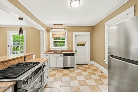 a kitchen with a stove a sink and a refrigerator