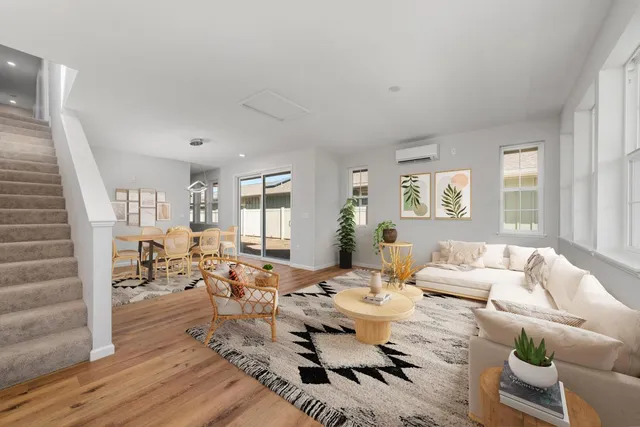 a living room with furniture window and wooden floor