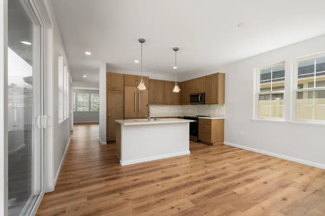 a large kitchen with a large counter top appliances and cabinets