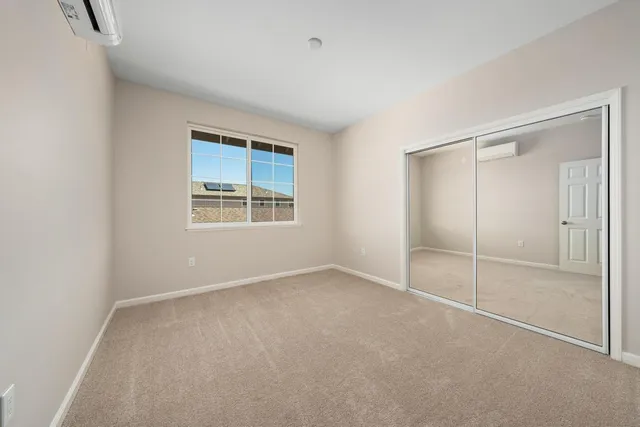 an empty room with windows and closet