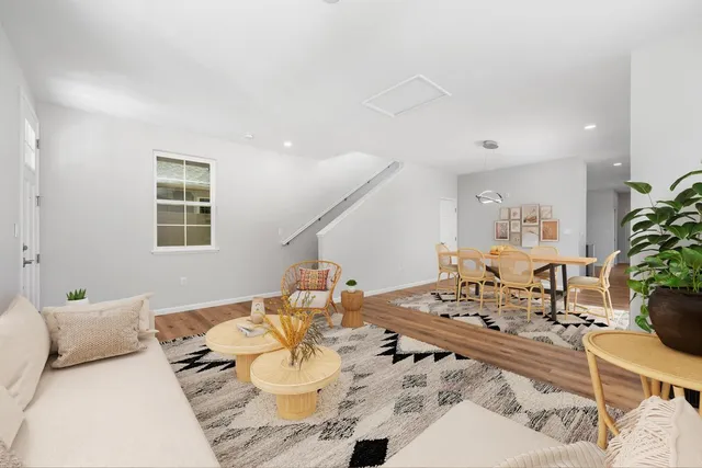 a living room with furniture and wooden floor