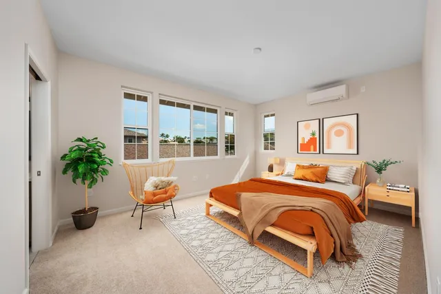 a bedroom with a bed and a potted plant