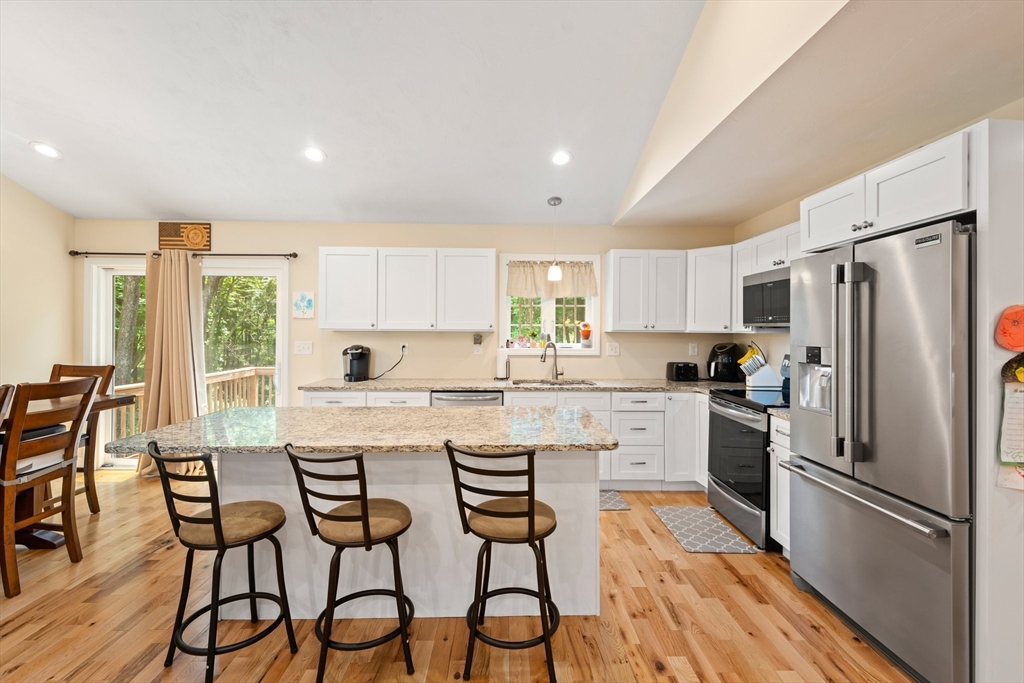 190 Lower Gore Road Webster, MA 01570 - Photo 16 of 41 a kitchen with white cabinets and stainless steel appliances
