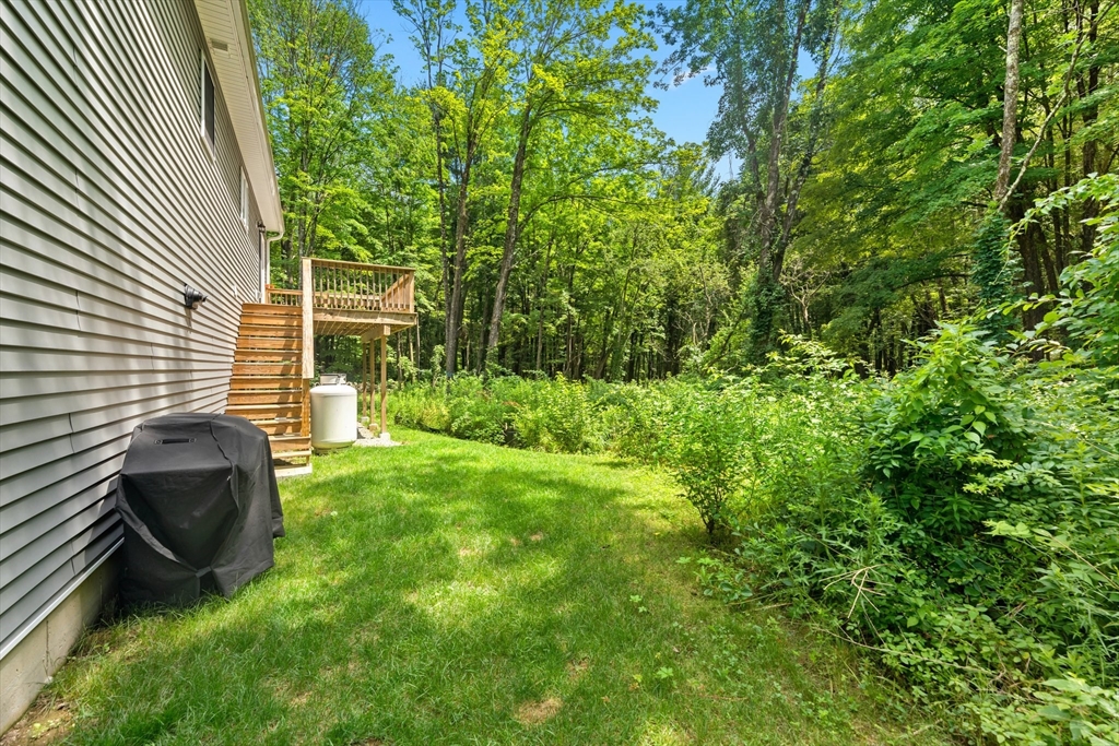 190 Lower Gore Road Webster, MA 01570 - Photo 7 of 41 a view of backyard with table and chairs and potted plants