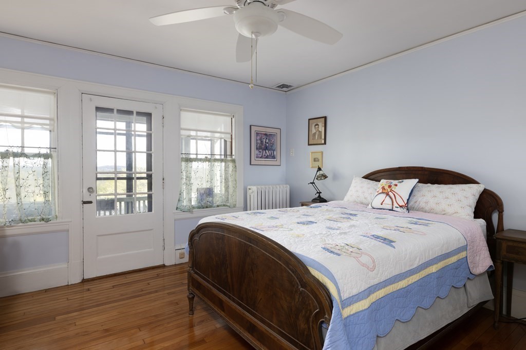 175 Mt Vernon Street Newton, MA 02465 - Photo 11 of 21 a bedroom with a bed and a large window
