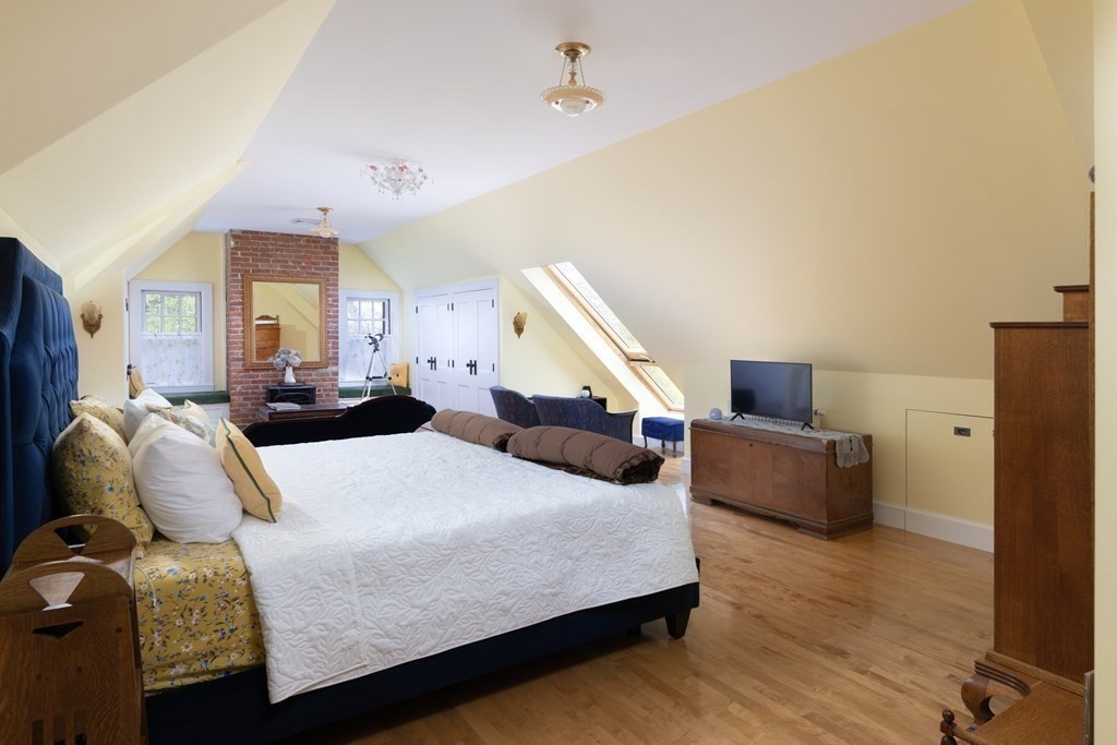 175 Mt Vernon Street Newton, MA 02465 - Photo 14 of 21 a bedroom with a bed and wooden floor