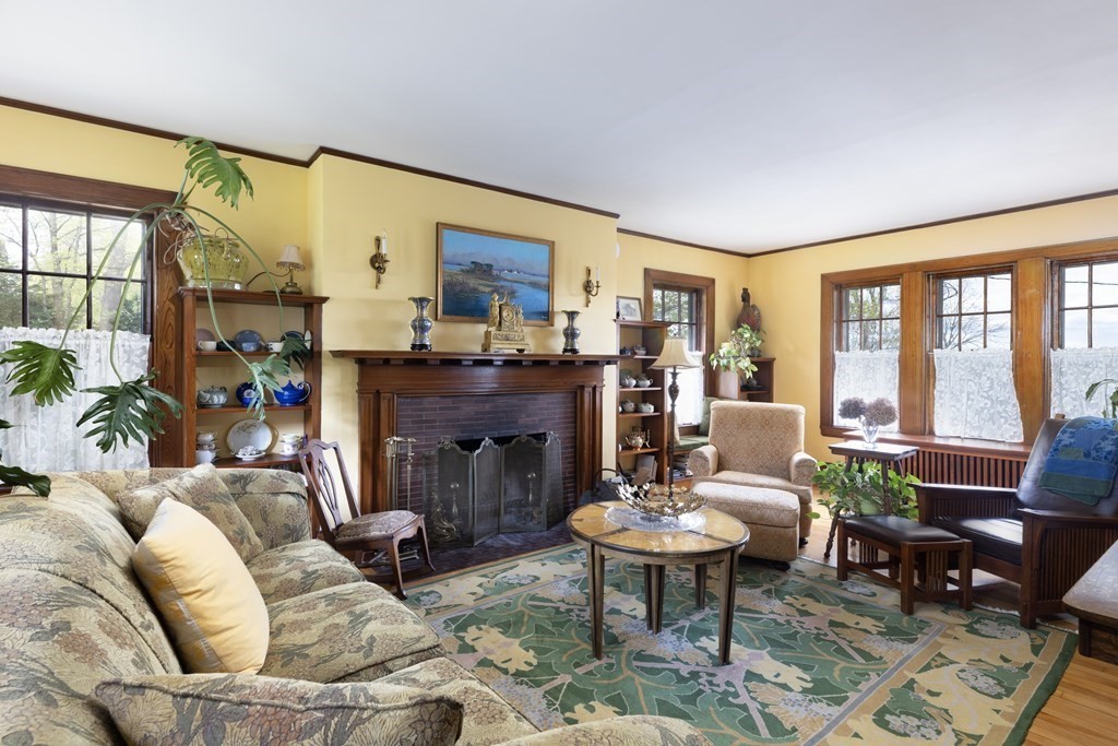 175 Mt Vernon Street Newton, MA 02465 - Photo 6 of 21 a living room with furniture a fireplace and a floor to ceiling window