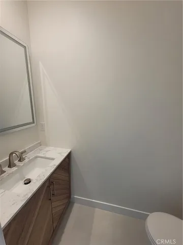 a bathroom with a sink vanity and toilet