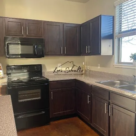 a kitchen with a sink stove and microwave