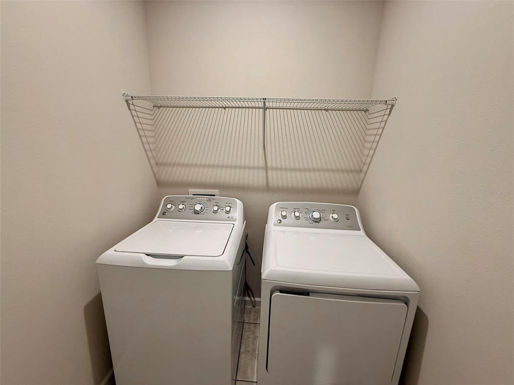 5576 Vigo Loop St. Cloud, FL 34771 - Photo 11 of 17 a utility room with dryer and washer