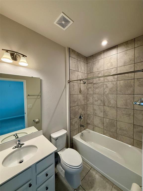 5576 Vigo Loop St. Cloud, FL 34771 - Photo 14 of 17 a bathroom with a bathtub shower sink mirror vanity and toilet