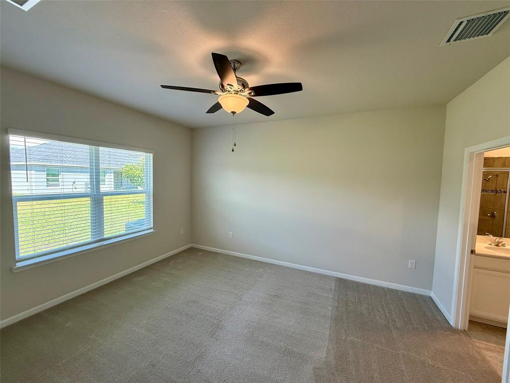 5576 Vigo Loop St. Cloud, FL 34771 - Photo 6 of 17 an empty room with windows and fan view