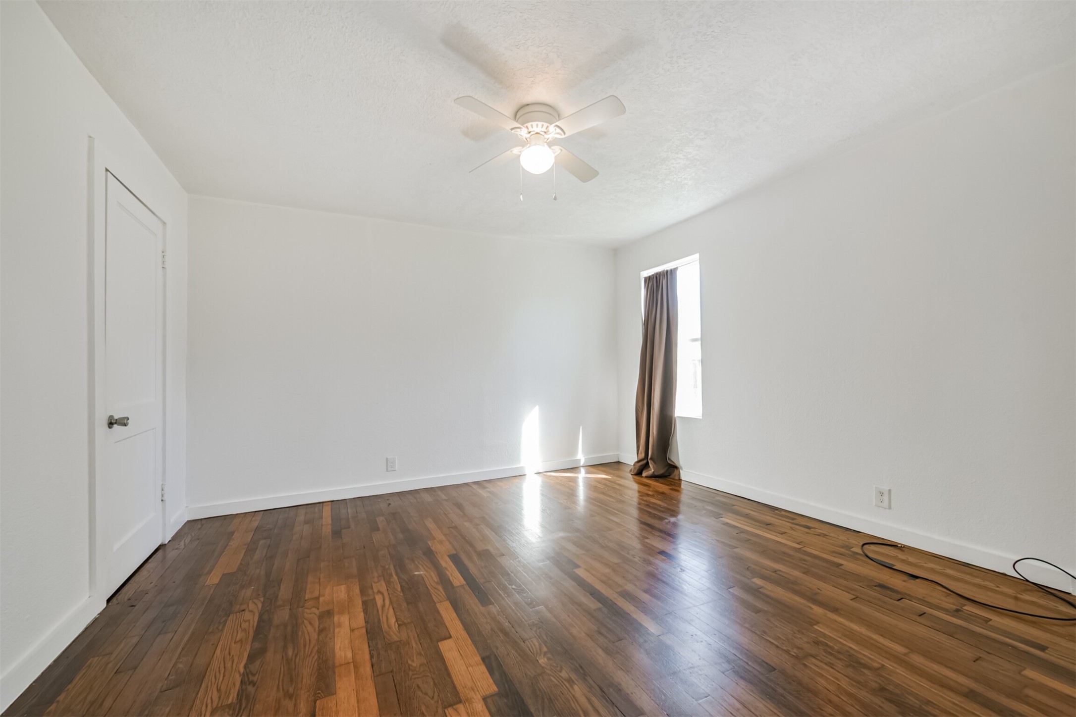 7546 Greendowns Street Houston, TX 77087 - Photo 23 of 33 a view of an empty room with wooden floor