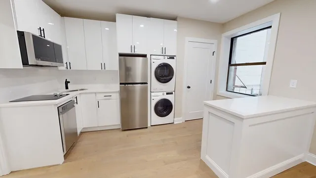 a utility room with sink dryer and washer