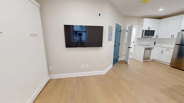 a view of a kitchen with white cabinets