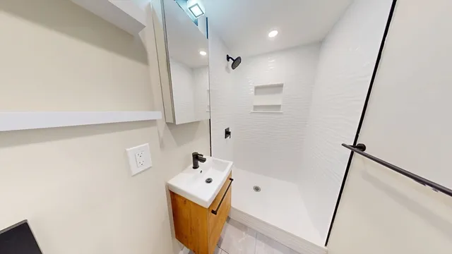 a bathroom with a tub sink and mirror