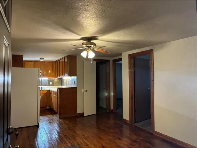 a view of kitchen with stainless steel appliances granite countertop a refrigerator and a sink