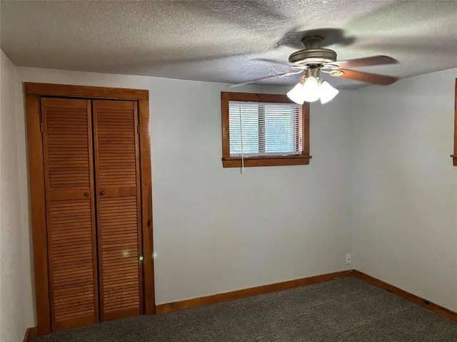 en view of a livingroom with a chandelier fan
