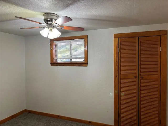 a view of a livingroom with a chandelier fan