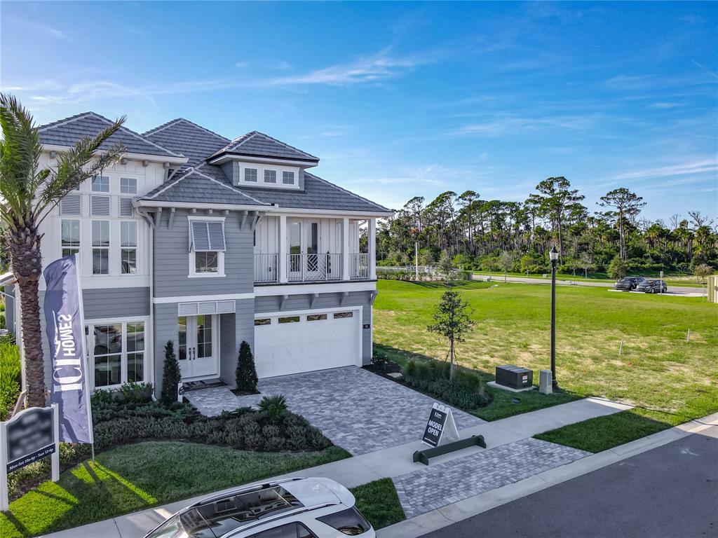 81 Coronado Road Flagler Beach, FL 32136 - Photo 11 of 27 a front view of a house with a garden and lake view