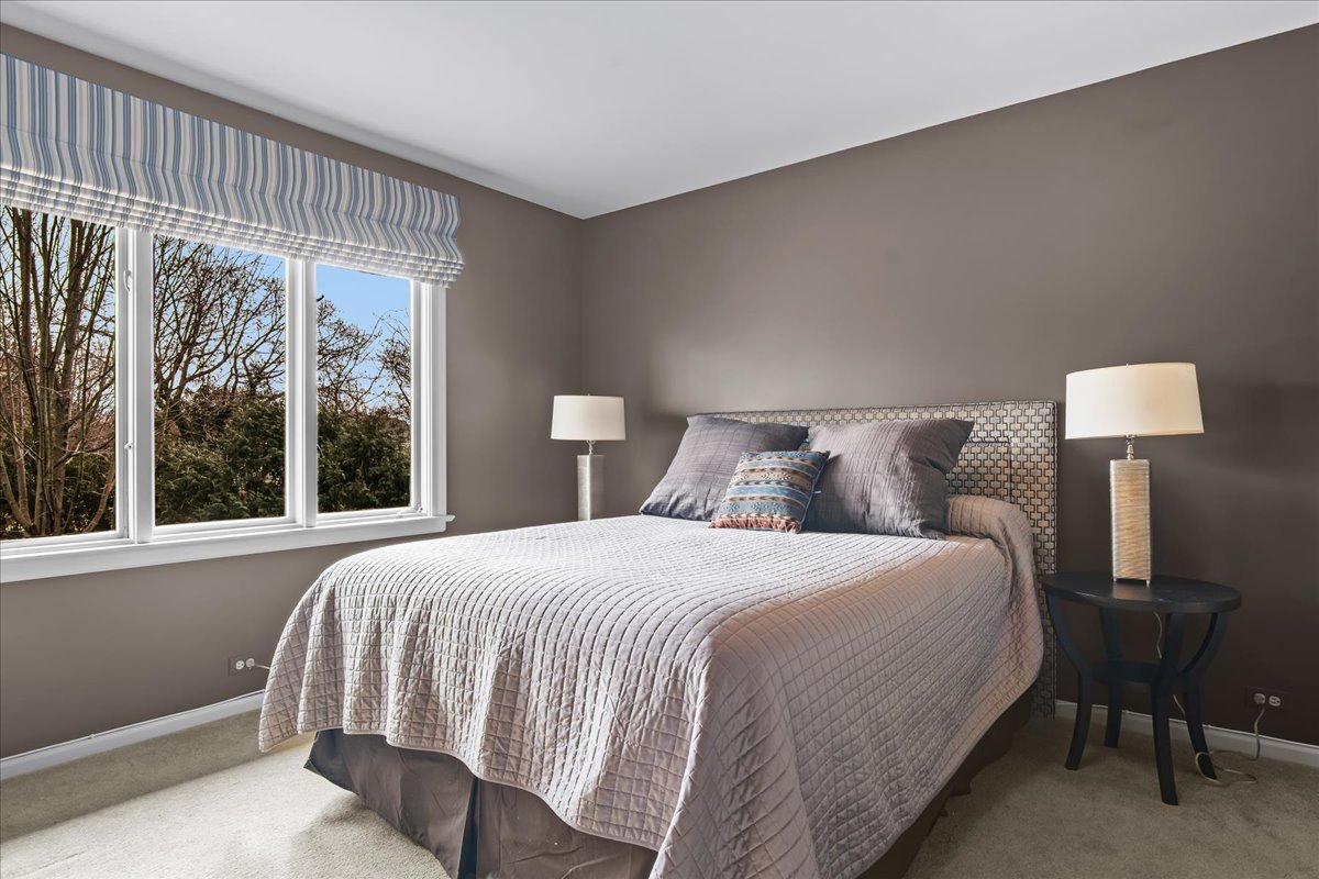 1424 Ridge Road Northbrook, IL 60062 - Photo 22 of 32 a bedroom with a bed lamp and window