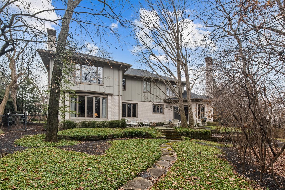 1424 Ridge Road Northbrook, IL 60062 - Photo 28 of 32 a view of a white house with a yard and plants