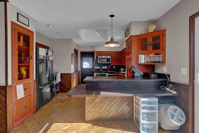 a view of living room kitchen with furniture and wooden floor
