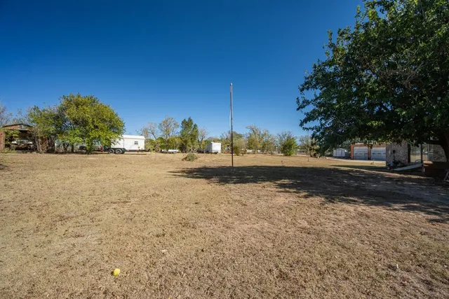 a spacious bedroom with a bed and a ceiling fan