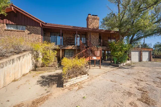 a view of a house with a snow on the road