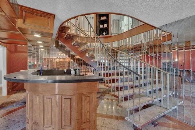 a kitchen with stainless steel appliances granite countertop a sink a counter space and cabinets