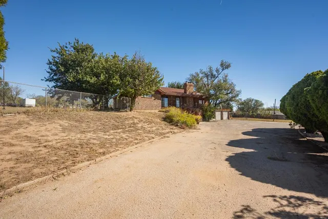a view of a yard with a tree