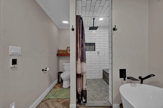 a view of walk in closet with clothes