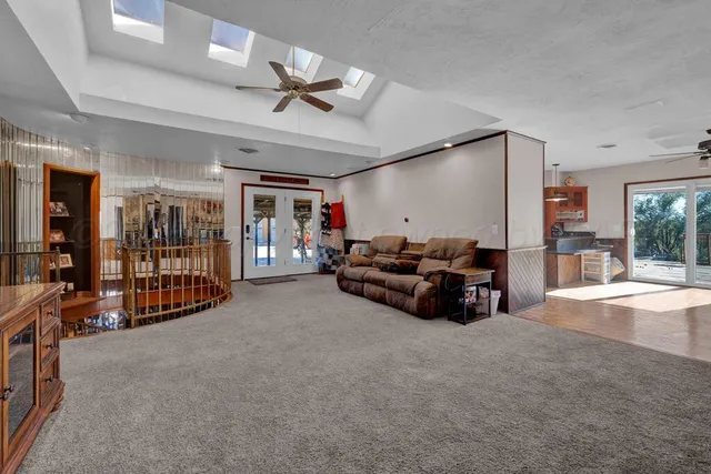 a very nice looking room with gym equipment and a chandelier