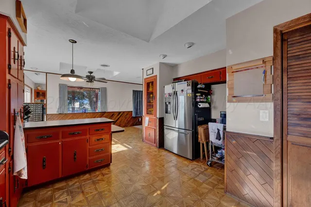 a kitchen with stainless steel appliances granite countertop a refrigerator and a sink
