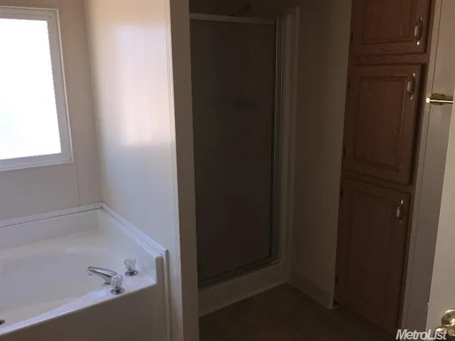 a view of walk in closet with empty racks