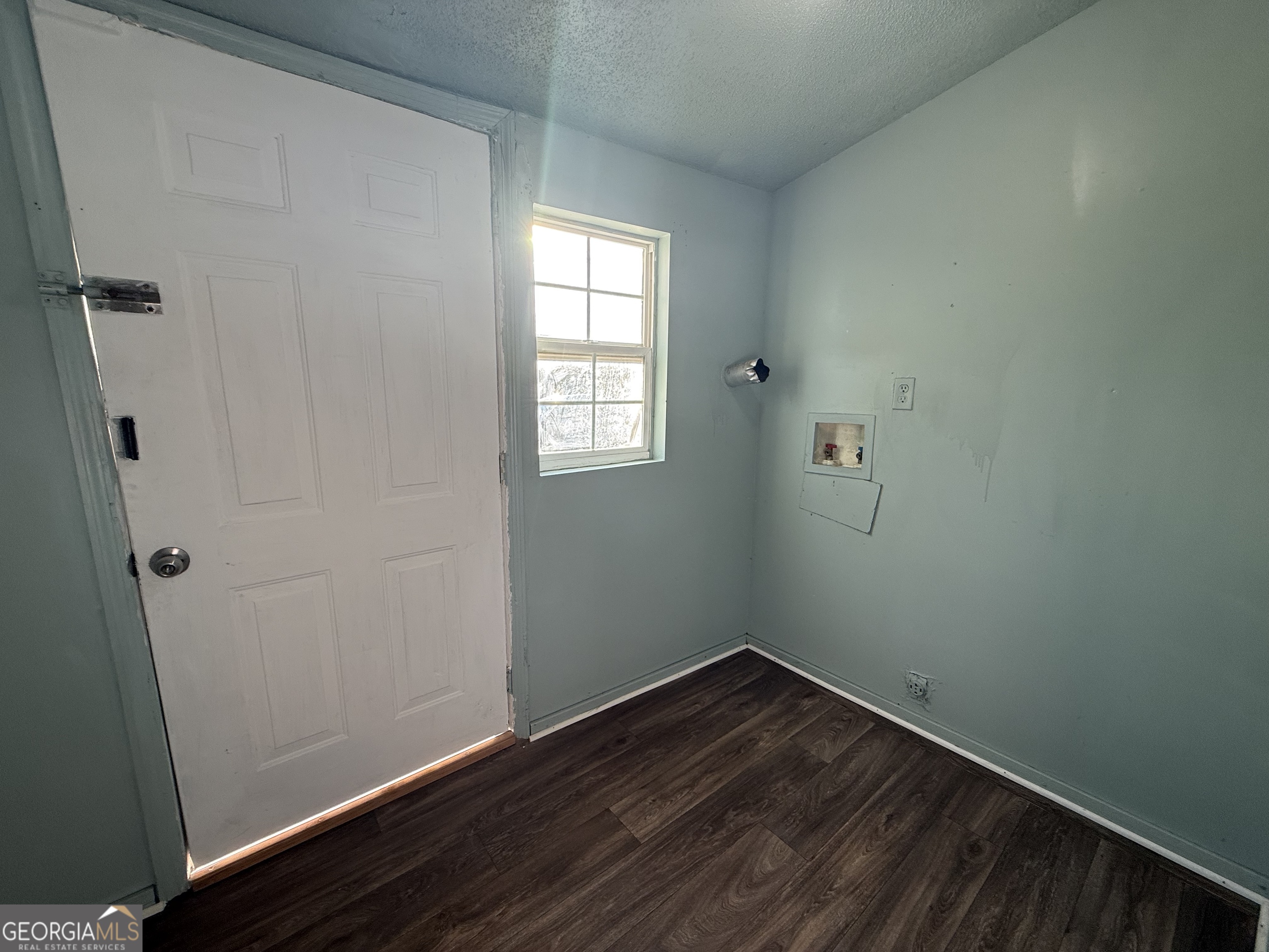 803 Pine Street Fort Valley, GA 31030 - Photo 12 of 22 a view of an empty room with wooden floor and a window