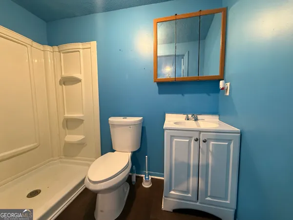 a white toilet sitting next to a bathroom sink