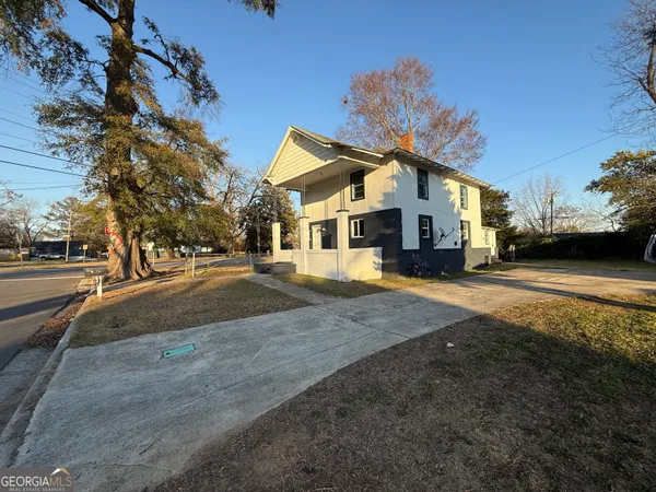 a front view of a building with a yard