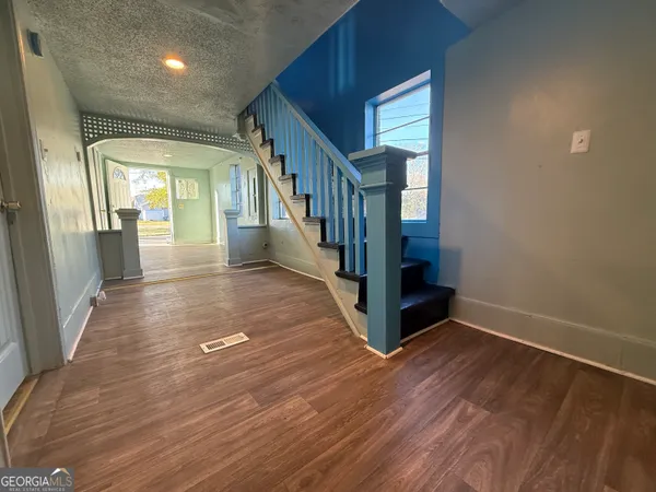 a view of an entryway with wooden floor