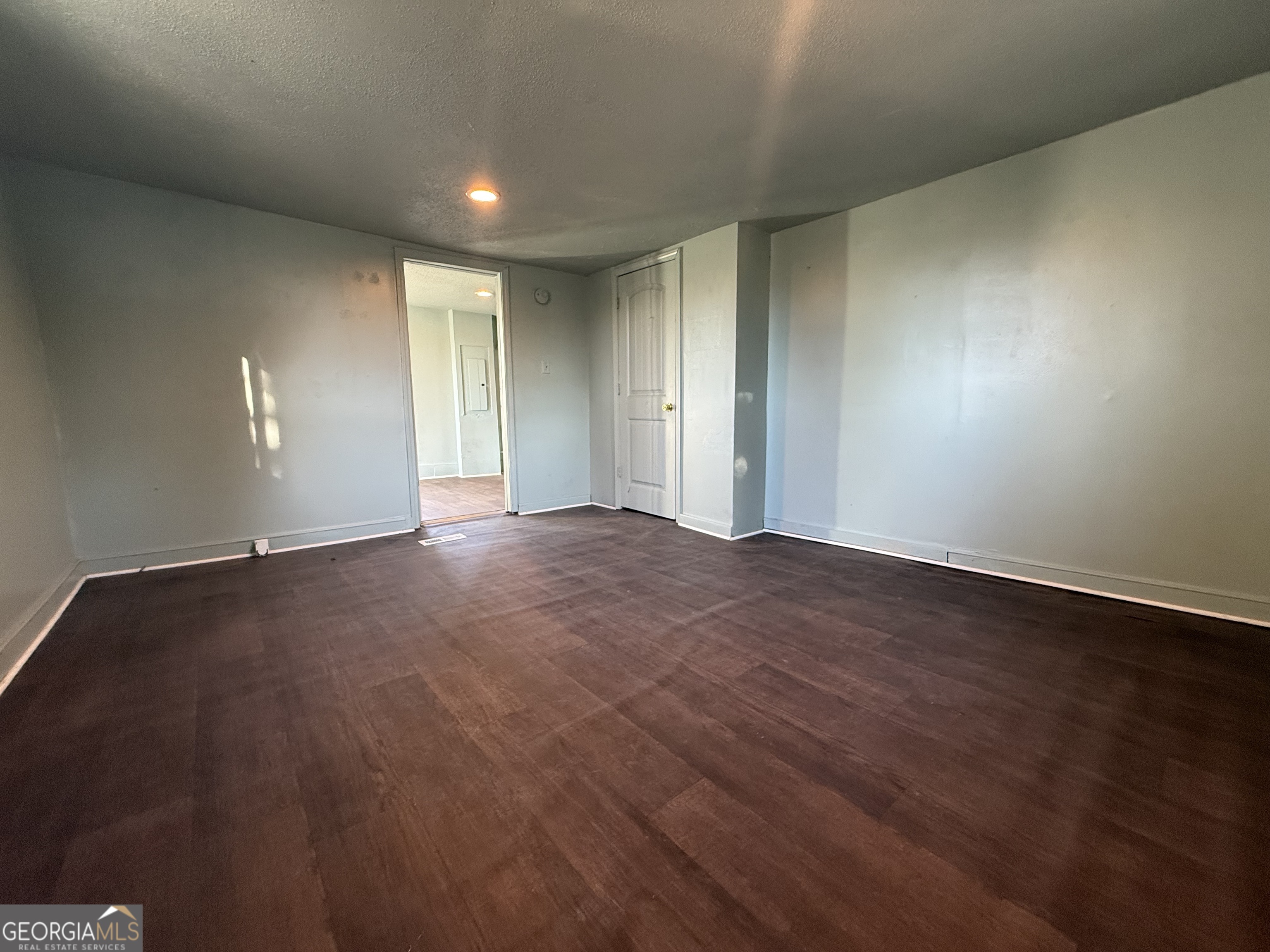 803 Pine Street Fort Valley, GA 31030 - Photo 5 of 22 a view of an empty room with wooden floor and a window