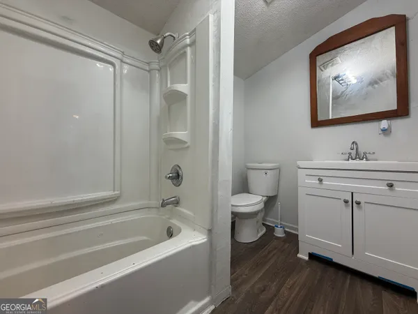 a bathroom with a toilet a sink and a bathtub