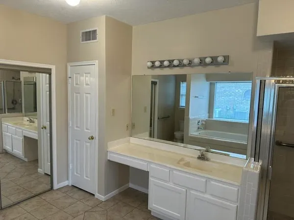 a bathroom with a shower sink and mirror