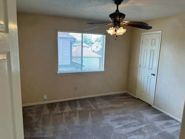 a view of wooden floor and a chandelier in a room