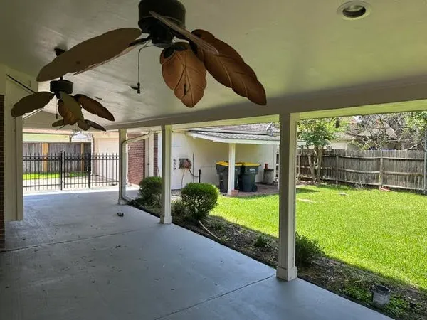 a view of a porch with furniture and garden