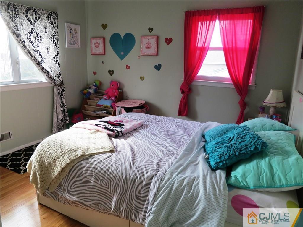 6 Colburn Road East Brunswick, NJ 08816 - Photo 14 of 24 a bedroom with a bed and window