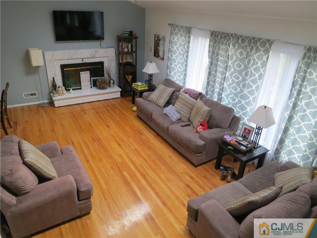 6 Colburn Road East Brunswick, NJ 08816 - Photo 4 of 24 a living room with furniture and a fireplace