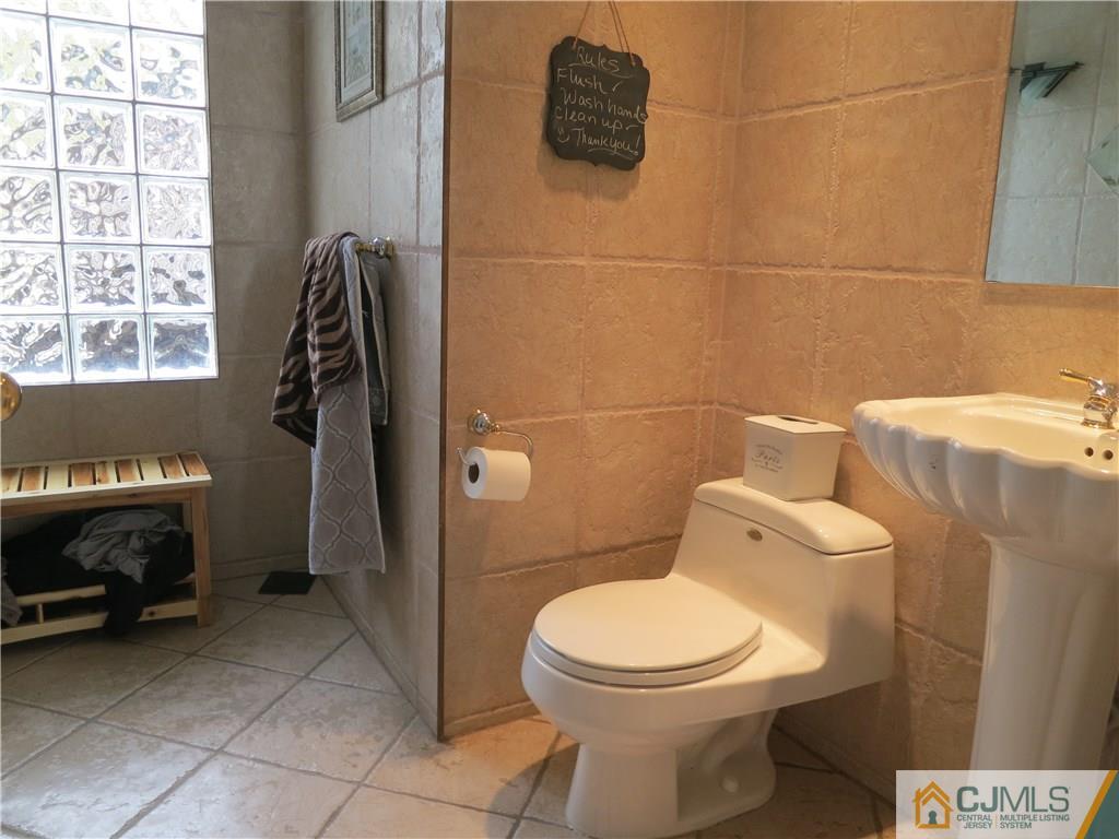 6 Colburn Road East Brunswick, NJ 08816 - Photo 9 of 24 a bathroom with a toilet and a shower
