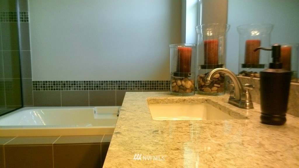 3601 176th Place Southeast, Unit 2009 Bothell, WA 98012 - Photo 11 of 19 a bathroom with a tub sink and mirror