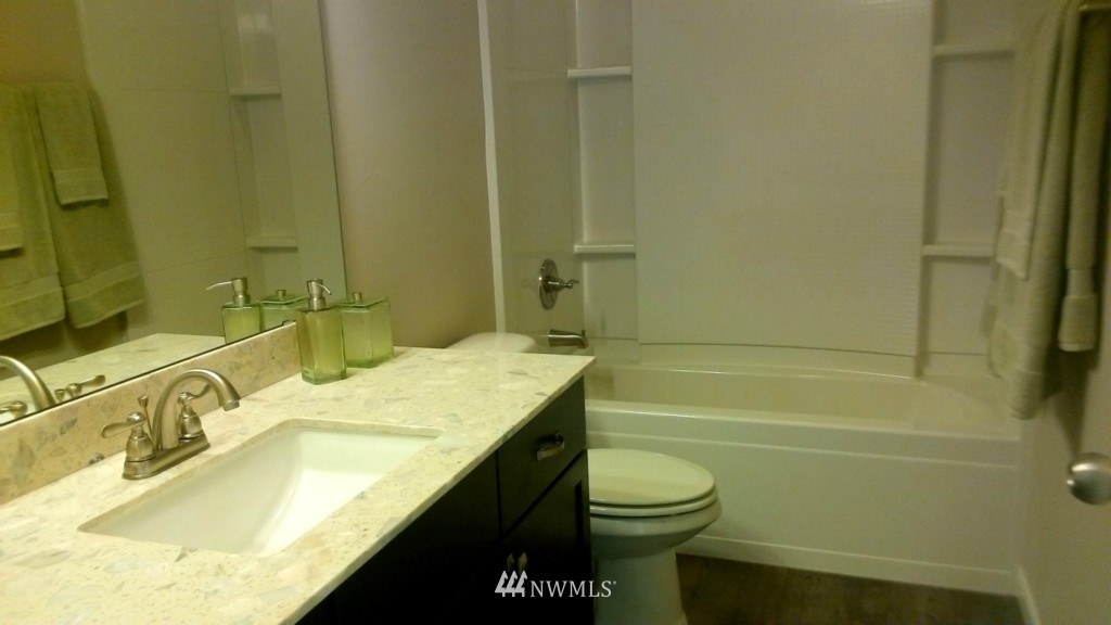 3601 176th Place Southeast, Unit 2009 Bothell, WA 98012 - Photo 13 of 19 a bathroom with a granite countertop bathtub sink vanity mirror and toilet