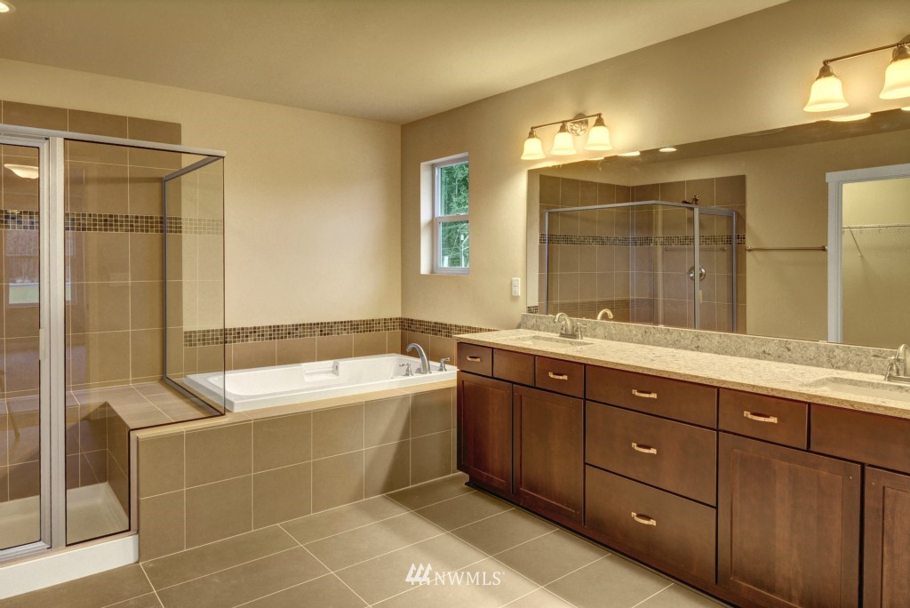 3601 176th Place Southeast, Unit 2009 Bothell, WA 98012 - Photo 10 of 19 a spacious bathroom with a tub sink shower and mirror